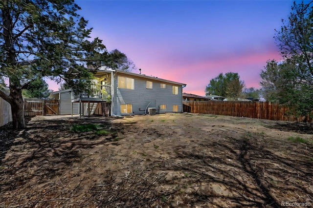 3516 Marigold St, Evans, CO 80620 - back of property at dusk featuring a fenced backyard and central air condition unit
