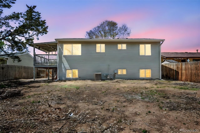3516 Marigold St, Evans, CO 80620 - back of property with a fenced backyard, a wooden deck, and central AC unit
