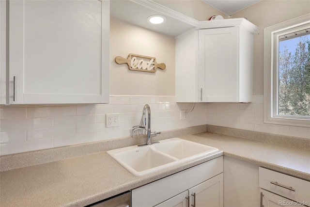 3516 Marigold St, Evans, CO 80620 - kitchen featuring a sink, white cabinetry, decorative backsplash, and light countertops