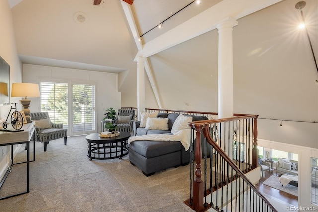 living room featuring high vaulted ceiling, rail lighting, ceiling fan, and ornate columns