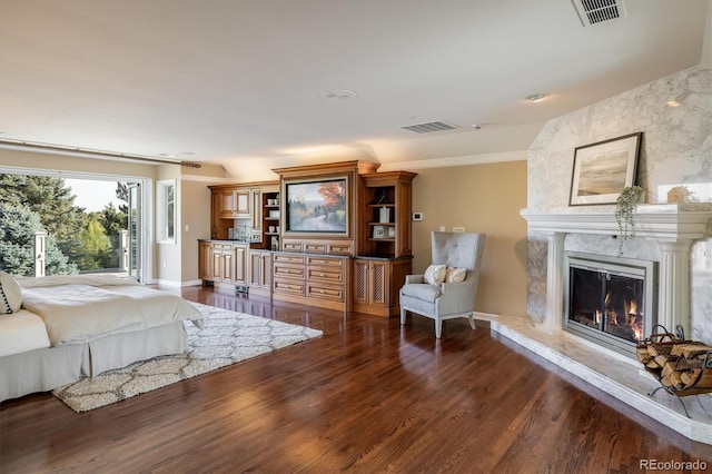 bedroom featuring dark hardwood / wood-style floors and a fireplace