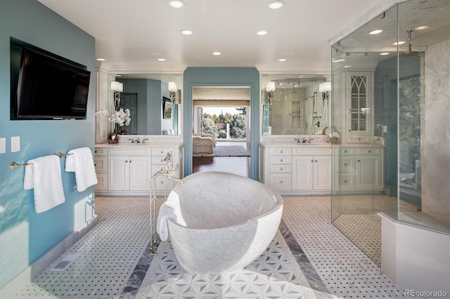 bathroom featuring a shower with door and vanity