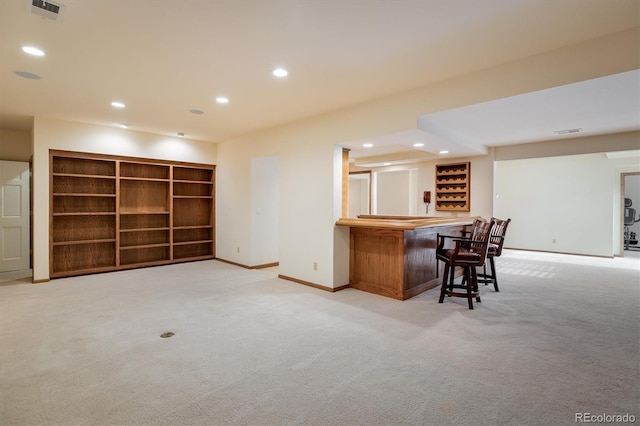 bar featuring built in shelves and light colored carpet