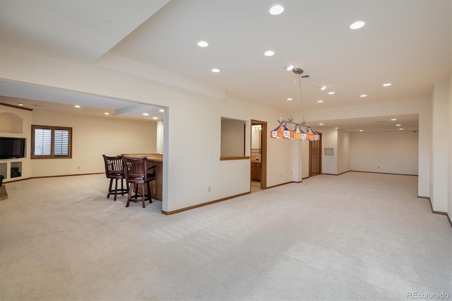 carpeted living room with bar area