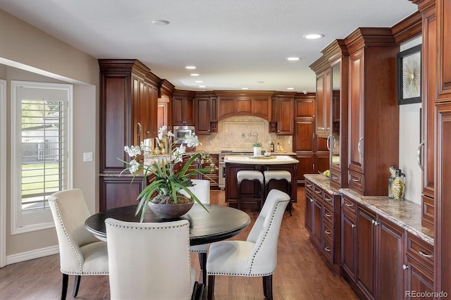 dining space with dark hardwood / wood-style flooring