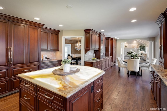 kitchen with a center island, dark wood-type flooring, wooden counters, and decorative backsplash