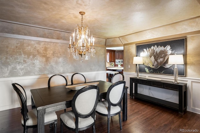 dining room with a notable chandelier and dark wood-type flooring