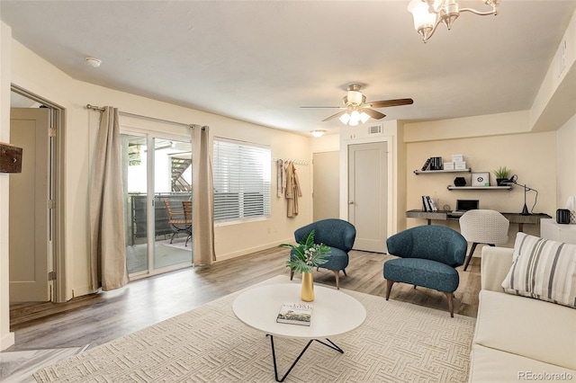 living room featuring ceiling fan and light hardwood / wood-style flooring