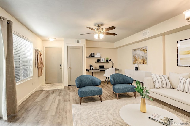 living room with ceiling fan and light wood-type flooring