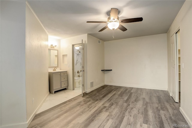 unfurnished bedroom featuring light wood-style flooring, baseboards, and visible vents