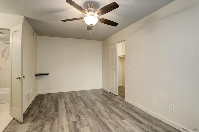 unfurnished bedroom with baseboards, visible vents, and wood finished floors