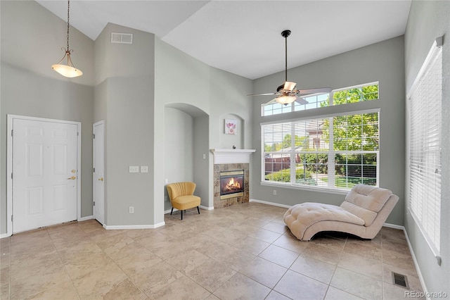14333 E Napa Pl Unit 5D, Aurora, CO 80014 - living area featuring ceiling fan, a towering ceiling, a fireplace, and baseboards