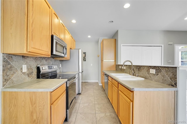 14333 E Napa Pl Unit 5D, Aurora, CO 80014 - kitchen featuring stainless steel appliances, a sink, backsplash, light countertops, and recessed lighting