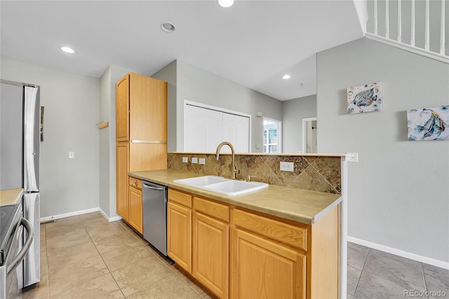 14333 E Napa Pl Unit 5D, Aurora, CO 80014 - kitchen featuring a sink, stainless steel appliances, backsplash, light countertops, and baseboards