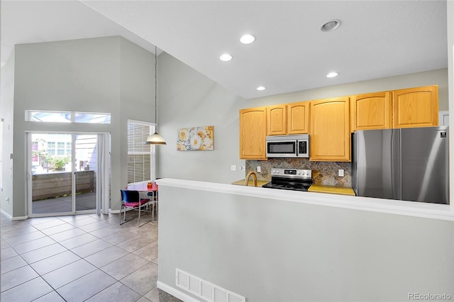 14333 E Napa Pl Unit 5D, Aurora, CO 80014 - kitchen featuring stainless steel appliances, baseboards, high vaulted ceiling, decorative backsplash, and light tile patterned flooring