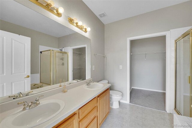 14333 E Napa Pl Unit 5D, Aurora, CO 80014 - full bathroom featuring a stall shower, a walk in closet, toilet, and double vanity