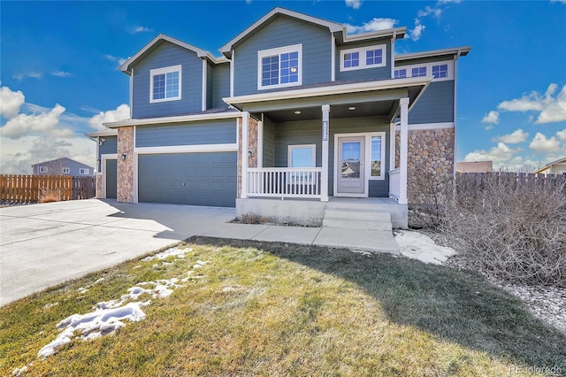 view of front of house with a garage, a front lawn, and a porch