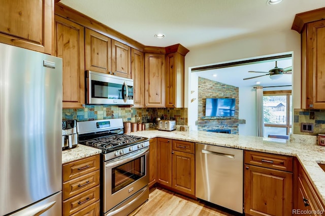 68 Golf Course Dr Unit 11, Copper Mountain, CO 80443 - kitchen with appliances with stainless steel finishes, brown cabinets, tasteful backsplash, and vaulted ceiling