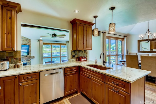 68 Golf Course Dr Unit 11, Copper Mountain, CO 80443 - kitchen with dishwasher, a sink, a peninsula, brown cabinets, and tasteful backsplash