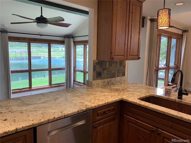 68 Golf Course Dr Unit 11, Copper Mountain, CO 80443 - kitchen with stainless steel dishwasher, a sink, ceiling fan, light stone countertops, and plenty of natural light