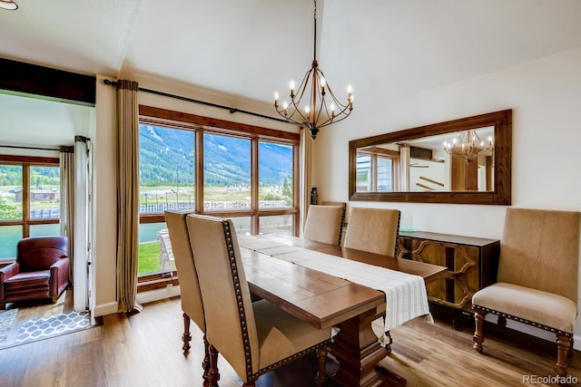 68 Golf Course Dr Unit 11, Copper Mountain, CO 80443 - dining space featuring a chandelier, wood finished floors, plenty of natural light, and lofted ceiling