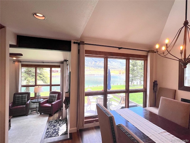68 Golf Course Dr Unit 11, Copper Mountain, CO 80443 - dining room featuring a chandelier, recessed lighting, vaulted ceiling, and wood finished floors