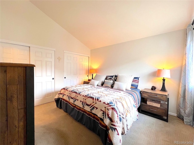 68 Golf Course Dr Unit 11, Copper Mountain, CO 80443 - bedroom with light colored carpet, multiple closets, vaulted ceiling, and baseboards