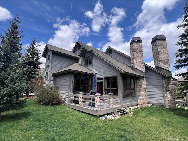 68 Golf Course Dr Unit 11, Copper Mountain, CO 80443 - rear view of property with a wooden deck, a yard, a chimney, and roof with shingles