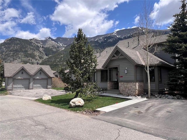 68 Golf Course Dr Unit 11, Copper Mountain, CO 80443 - view of front of house featuring a mountain view, stone siding, driveway, and a front yard