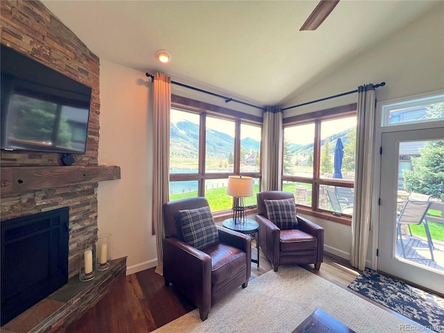 68 Golf Course Dr Unit 11, Copper Mountain, CO 80443 - sitting room featuring vaulted ceiling, a fireplace, wood finished floors, and baseboards