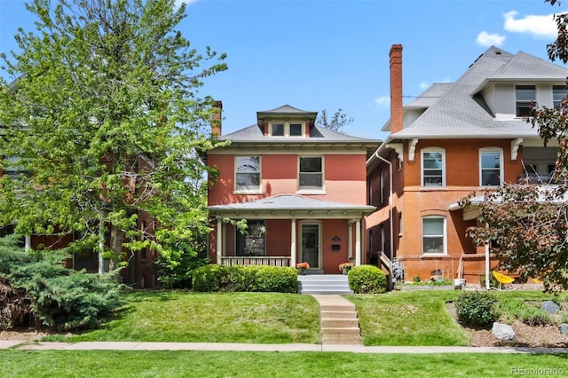 traditional style home featuring covered porch, a front lawn, and a chimney