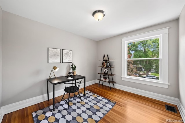 office space featuring baseboards and wood finished floors