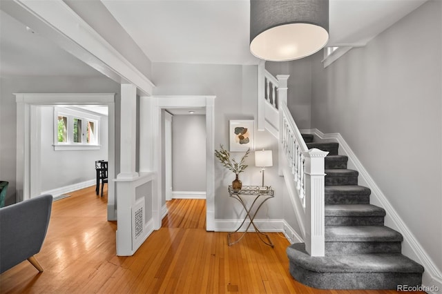stairs with wood-type flooring and baseboards