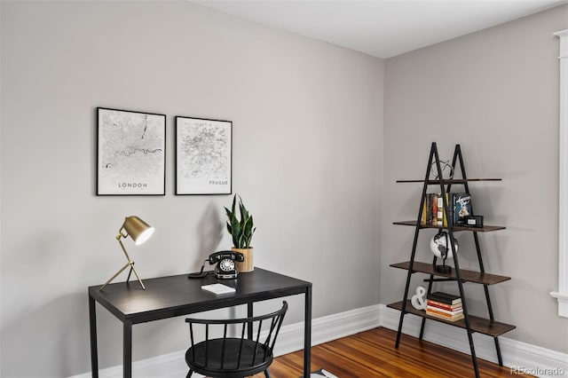 office space featuring baseboards and wood finished floors