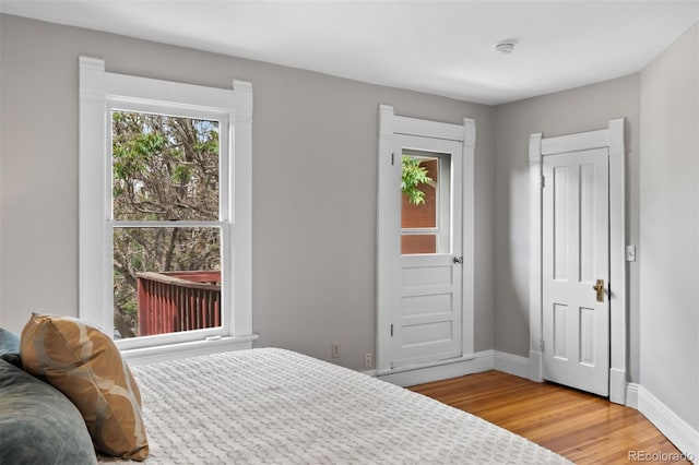 bedroom with light wood-type flooring and baseboards