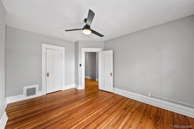 unfurnished bedroom with baseboards, light wood-style floors, and a ceiling fan