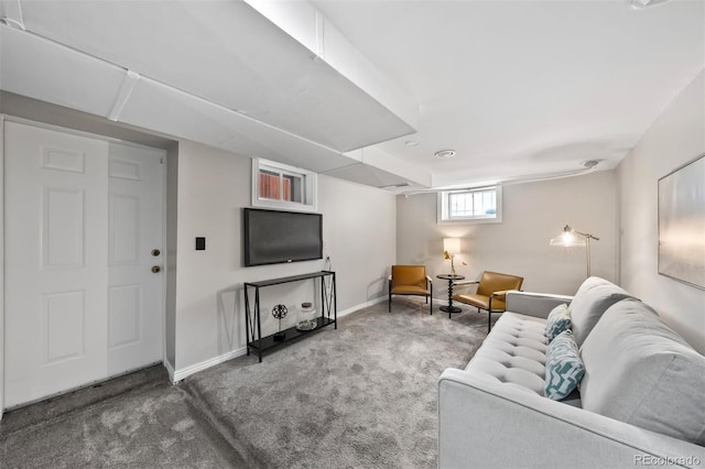 living area featuring carpet flooring and baseboards
