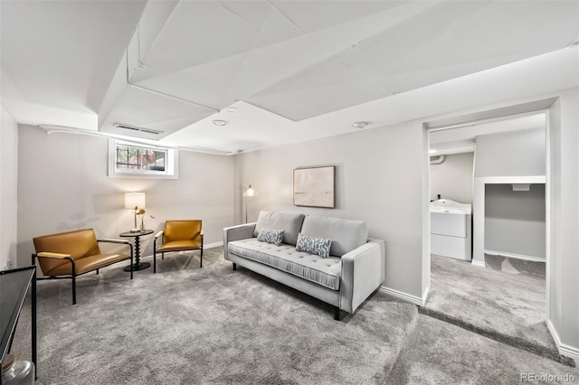 living room featuring washer / clothes dryer, carpet floors, and baseboards