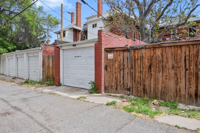 view of side of home with fence and brick siding