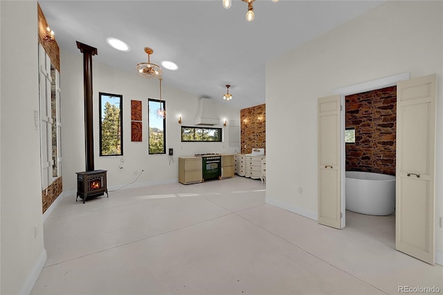 148 Ridge Ln, Bailey, CO 80421 - unfurnished living room with concrete flooring, a wood stove, and lofted ceiling