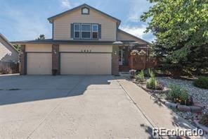 traditional home with driveway and an attached garage