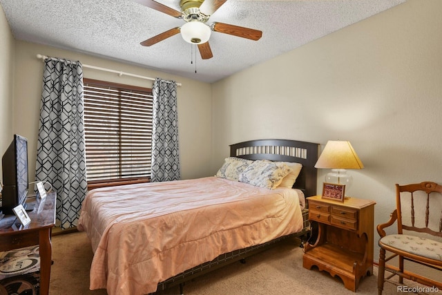 carpeted bedroom with a textured ceiling and a ceiling fan