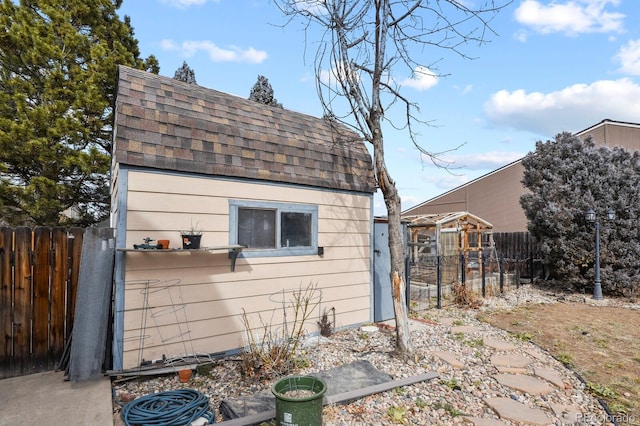 view of outbuilding with an outbuilding and fence