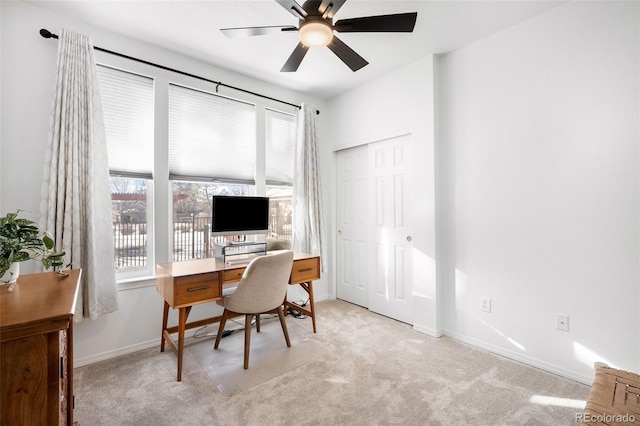 office with light carpet and ceiling fan