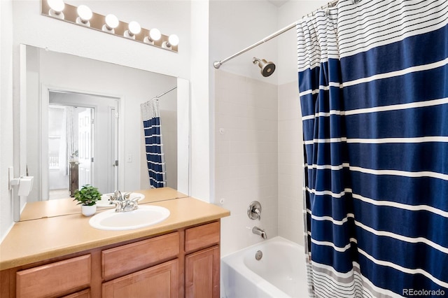 bathroom with shower / bathtub combination with curtain and vanity