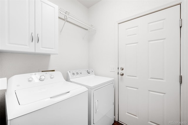 washroom featuring cabinets and separate washer and dryer