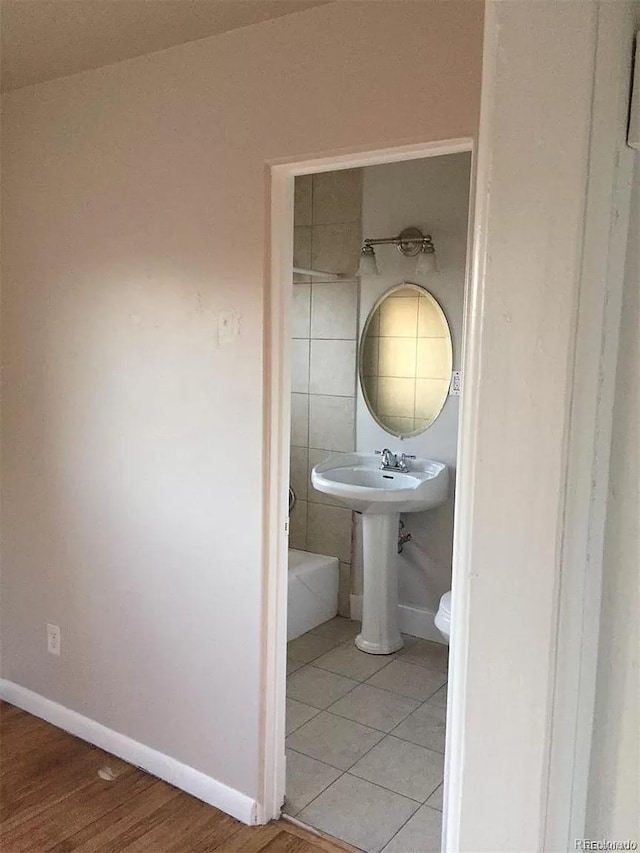 bathroom featuring hardwood / wood-style floors and toilet