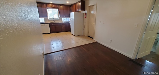 kitchen with light hardwood / wood-style flooring, sink, and white appliances