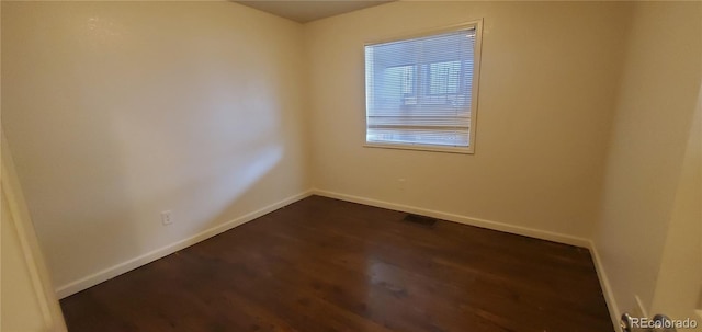 empty room with dark hardwood / wood-style floors