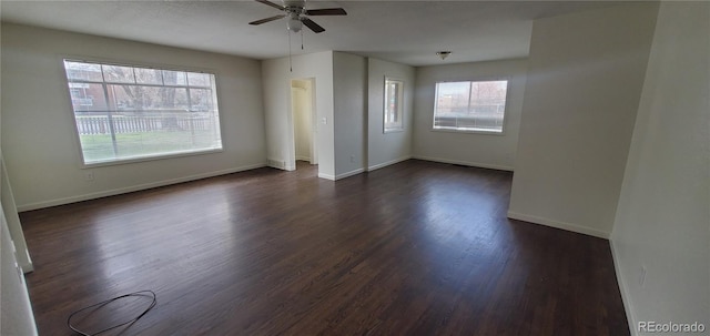 empty room with dark hardwood / wood-style floors and ceiling fan